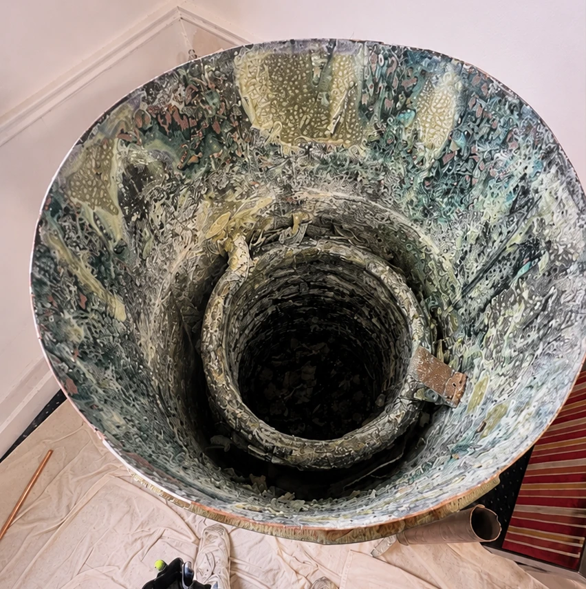 Hot water cylinder cut in half showing around 80 kg of limescale build-up caused by hard water